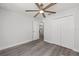 Bedroom with wood-look flooring, a ceiling fan, and closet, providing ample storage at 15304 Sw 27 Ln, Ocala, FL 34481