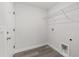 Practical laundry room with washer and dryer hookups, a wire shelf, and convenient access to the house at 15304 Sw 27 Ln, Ocala, FL 34481