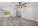 Bright, open living room with gray flooring, ceiling fan, and view to the outdoors at 15304 Sw 27 Ln, Ocala, FL 34481