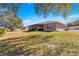 House exterior showcasing a screened patio and large backyard at 1561 Ne 160Th Pl, Citra, FL 32113