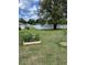 Spacious backyard with large tree and raised garden bed at 1561 Ne 160Th Pl, Citra, FL 32113