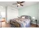 Bedroom with modern ceiling fan, soft mint green walls, and stylish metal frame bed at 1561 Ne 160Th Pl, Citra, FL 32113