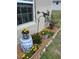 Landscaped garden with various plants, flowers, decorative rocks, and charming garden accents at 1561 Ne 160Th Pl, Citra, FL 32113