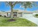 One-story house with two-car garage, manicured lawn, and mature tree at 16205 Sw 12Th Ter, Ocala, FL 34473