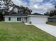 Charming single-story home features a well-manicured lawn, attached garage, and neutral green paint at 17656 Sw 113Th Pl, Dunnellon, FL 34432