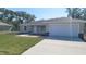 Charming single-story home featuring a two-car garage and well-manicured lawn at 17682 Sw 113Th Pl, Dunnellon, FL 34432