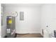 Water heater and electric panel in the basement utility area with wood flooring at 2270 Sw 141St Ter, Ocala, FL 34481