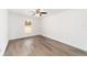 Bedroom with wood-look floors, a ceiling fan, and a window with a view of the yard at 2270 Sw 141St Ter, Ocala, FL 34481