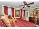 King bed, red bedding and gold accents in this well-lit bedroom at 2418 Ne 7Th St # 10, Ocala, FL 34470