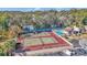 Aerial view of community tennis courts, pool, and surrounding landscape at 2418 Ne 7Th St # 10, Ocala, FL 34470