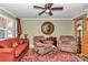 Relaxing living room featuring a large clock and comfy seating at 2418 Ne 7Th St # 10, Ocala, FL 34470