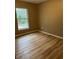 Bright bedroom with wood-look floors and a large window at 2515 Nw 63Rd Pl, Ocala, FL 34475