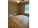 Simple bedroom with light brown wood-look flooring and a ceiling fan at 2515 Nw 63Rd Pl, Ocala, FL 34475