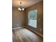 Bright dining room with wood-look flooring and a chandelier at 2515 Nw 63Rd Pl, Ocala, FL 34475