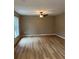 Spacious living room with light brown wood-look flooring and a ceiling fan at 2515 Nw 63Rd Pl, Ocala, FL 34475