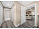 Bright hallway with wood-look floors and doors leading to other rooms at 2701 Sw 175Th Loop, Ocala, FL 34473