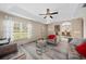 Living room featuring gray sofas and a view into the dining area at 2701 Sw 175Th Loop, Ocala, FL 34473