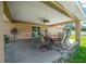 Covered patio with ceiling fan and outdoor dining furniture at 2701 Sw 175Th Loop, Ocala, FL 34473