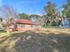 Large backyard with grassy area and mature trees at 309 Ne Sanchez Ave, Ocala, FL 34470