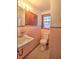 Bathroom with pink tile, toilet and sink vanity at 309 Ne Sanchez Ave, Ocala, FL 34470