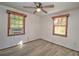 Spacious bedroom with two windows and vinyl flooring at 309 Ne Sanchez Ave, Ocala, FL 34470