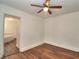 Simple bedroom with hardwood floors and ceiling fan at 317 Ne Sanchez Ave, Ocala, FL 34470