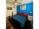 Bedroom with king bed, wood floors, and blue walls at 3396 Parkchester Square Blvd # 103, Orlando, FL 32835