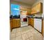 Well-equipped kitchen featuring wood cabinets and tile flooring at 3396 Parkchester Square Blvd # 103, Orlando, FL 32835