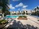 Community pool with lounge chairs and landscaping at 3396 Parkchester Square Blvd # 103, Orlando, FL 32835