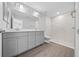 Modern bathroom featuring double vanity and marble-tiled shower at 4170 Se 131 Ln, Summerfield, FL 34491