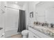 Bright bathroom featuring single sink vanity with granite counters, toilet, tub, and shower at 5450 Nw 46Th Lane Rd, Ocala, FL 34482