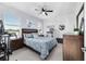 Bedroom features a ceiling fan and natural light from the windows at 5450 Nw 46Th Lane Rd, Ocala, FL 34482