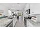 Well-lit kitchen featuring granite countertops and a view to the living room at 5450 Nw 46Th Lane Rd, Ocala, FL 34482