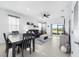 Bright living room featuring tile floors, a comfortable gray sofa, and sliding glass doors to the lanai at 5450 Nw 46Th Lane Rd, Ocala, FL 34482