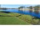 Scenic view of a lake with lush green grass and waterfront homes in the background at 623 Midway Dr # B, Ocala, FL 34472