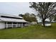 White barn with stalls and additional outbuildings on property at 6255 Mercantile Ln, Fort Meade, FL 33841