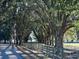 Long driveway lined with lush oak trees at 6255 Mercantile Ln, Fort Meade, FL 33841