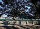 Wooden fence line with large oak trees in the background at 6255 Mercantile Ln, Fort Meade, FL 33841