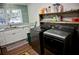 Laundry room with washer, dryer and storage shelves at 6255 Mercantile Ln, Fort Meade, FL 33841