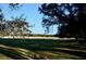 Open pasture with a white rail fence and large oak trees at 6255 Mercantile Ln, Fort Meade, FL 33841