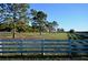 Open pasture with wood fence and mature trees at 6255 Mercantile Ln, Fort Meade, FL 33841