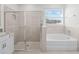 Main bathroom with a soaking tub, shower and updated vanity at 6267 Se 13Th St, Ocala, FL 34472