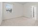 Simple bedroom with neutral-toned carpet and large window at 6267 Se 13Th St, Ocala, FL 34472