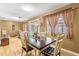 Charming dining area with a farmhouse table and checkered curtains at 6490 Sw 84Th St, Ocala, FL 34476