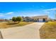 Single-story home with a paved driveway and landscaping at 6490 Sw 84Th St, Ocala, FL 34476