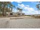 Tan mobile home with gray trim, wood steps, and a gravel driveway at 6555 Se 165Th Ave, Ocklawaha, FL 32179