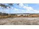 Open field with pond and distant trees under a partly cloudy sky at 6555 Se 165Th Ave, Ocklawaha, FL 32179