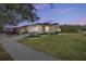 Single-story home with two-car garage, manicured lawn, and a paved driveway at 6767 Sw 91St Cir, Ocala, FL 34481