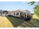 Exterior view of house with patio and lush landscaping at 6767 Sw 91St Cir, Ocala, FL 34481