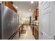 View of kitchen with stainless steel appliances and tile flooring at 6767 Sw 91St Cir, Ocala, FL 34481